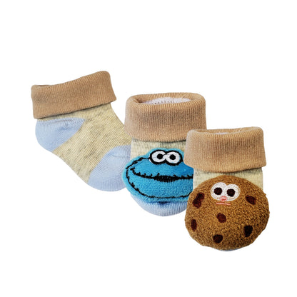 Baby socks with plush Cookie Monster head on one sock, and  a plush Cookie on the other socks. For infants 0 to 6 months
